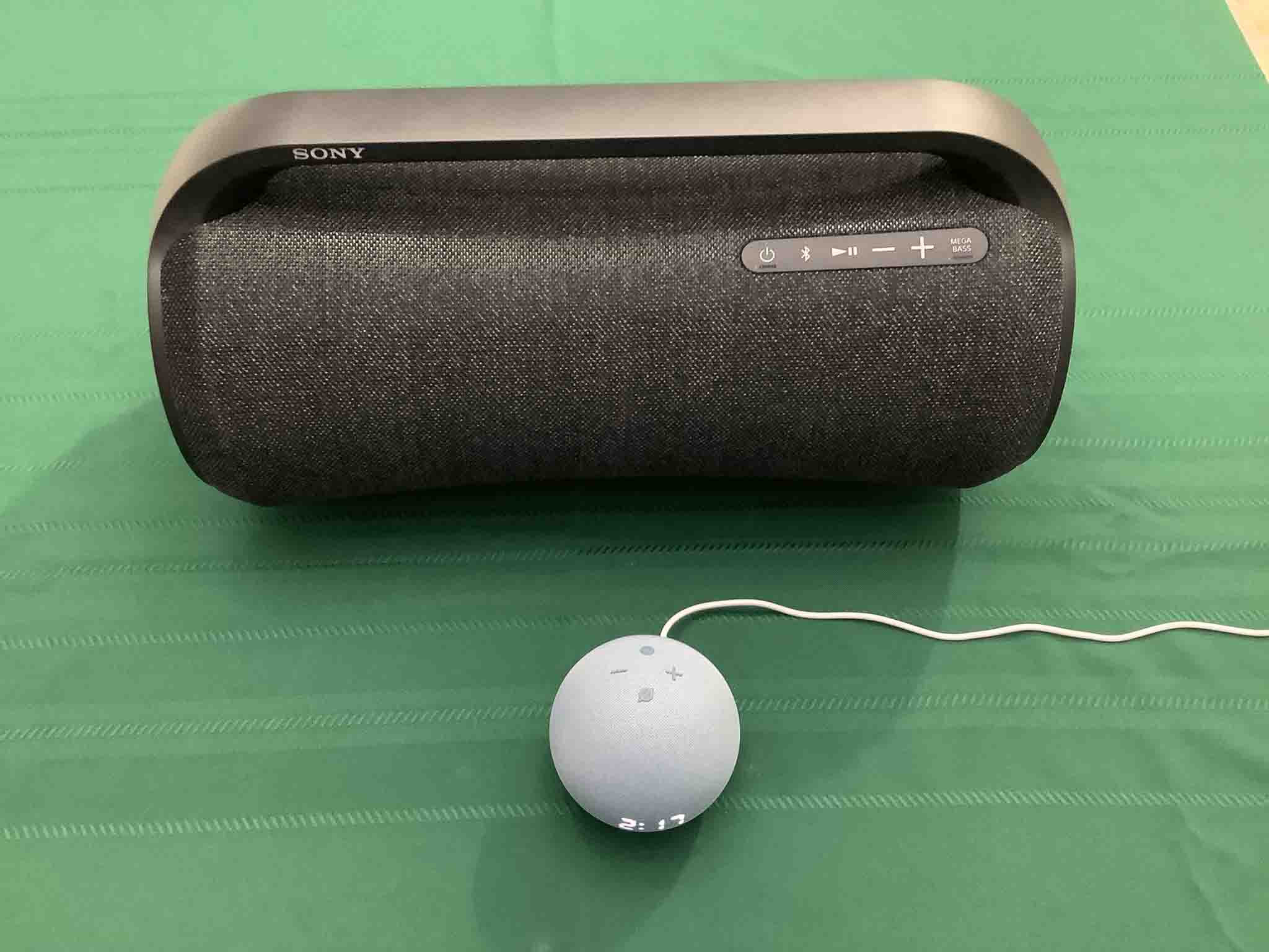 Picture of an Echo Dot clock speaker in front of a Sony SRS XG500 boombox.