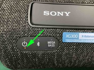Picture of the -CHARGE- indicator LED glowing orange on the Sony SRS XG300 stereo speaker.