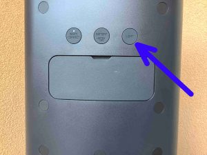 Picture of the -Light- button on the back of the speaker.