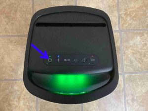 Picture of the -Power- button on the top of the Sony SRS XP500 speaker as it runs.